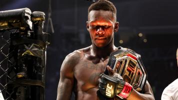 Israel Adesanya of Nigeria celebrates after defending his middleweight championship against Robert Whittaker of Australia during UFC 271 at Toyota Center on February 12, 2022 in Houston, Texas. (Photo by Carmen Mandato/Getty Images)